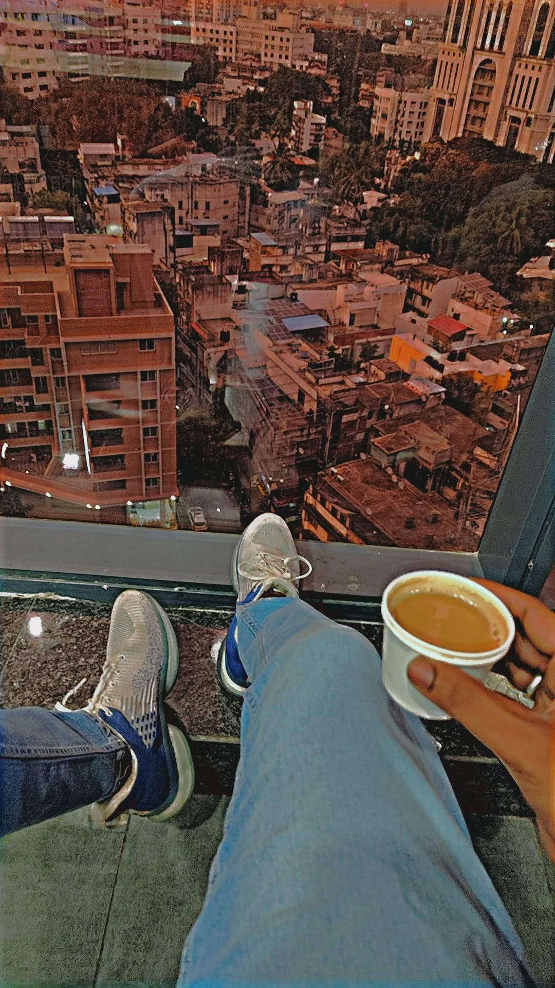 Mahendra Chiravande lifestyle view with tea and city skyline