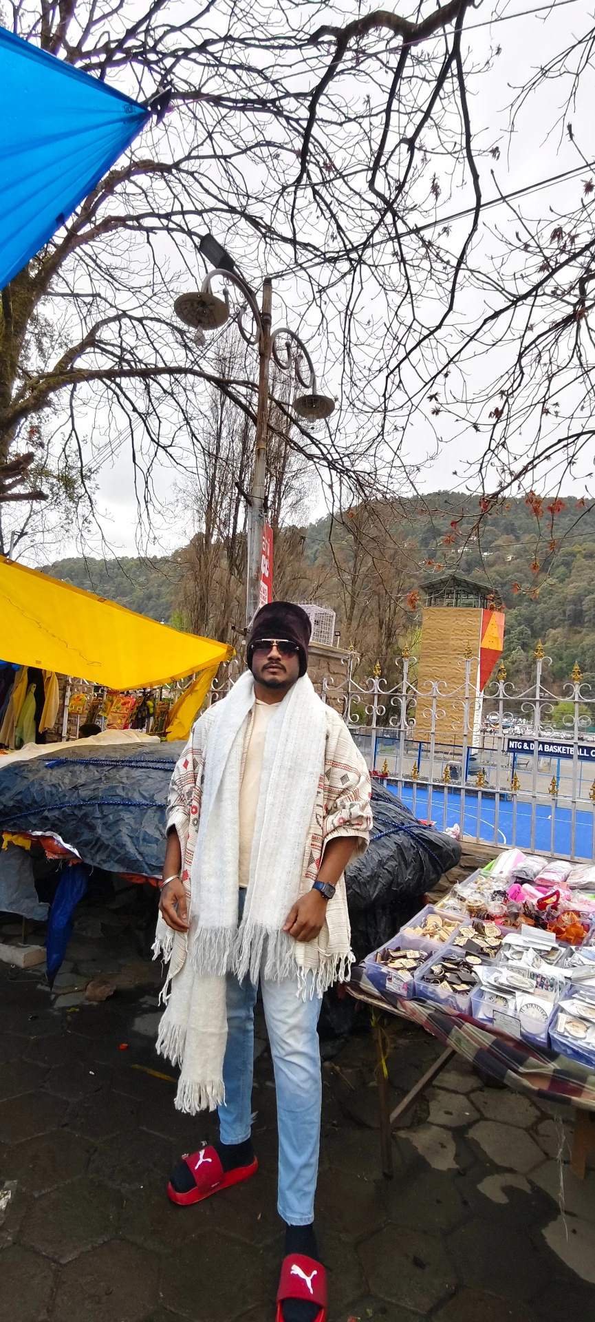 Mahendra Chiravande wearing winter clothing at an outdoor market