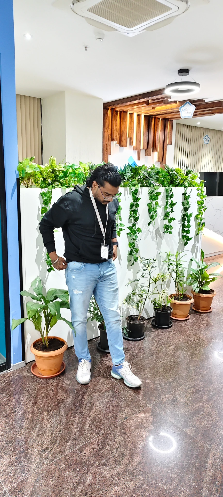 Mahendra Chiravande standing in a modern office corridor