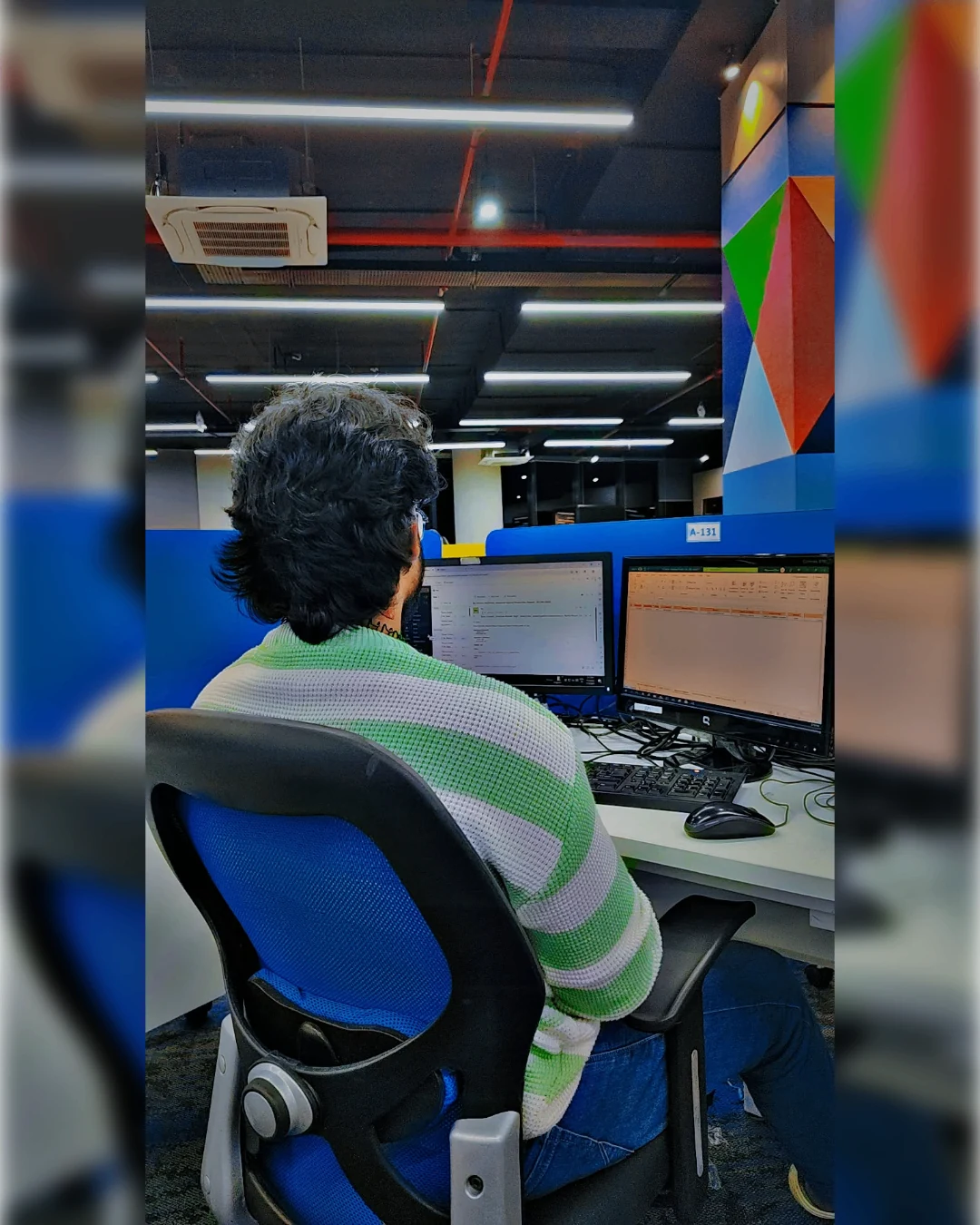 Mahendra Chiravande working at a software development workstation with monitors
